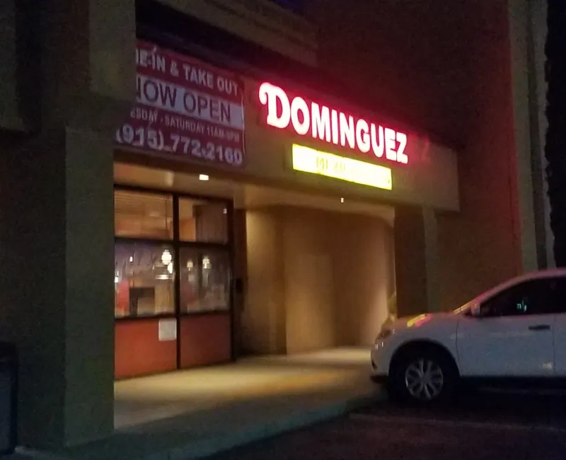 Dominguez storefront neon sign at night